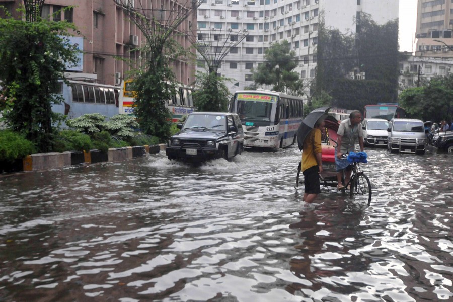 A brief shower inundated roads causing immense sufferings to the city dwellers. The photo was taken from the Motijheel area on Sunday.	— FE Photo