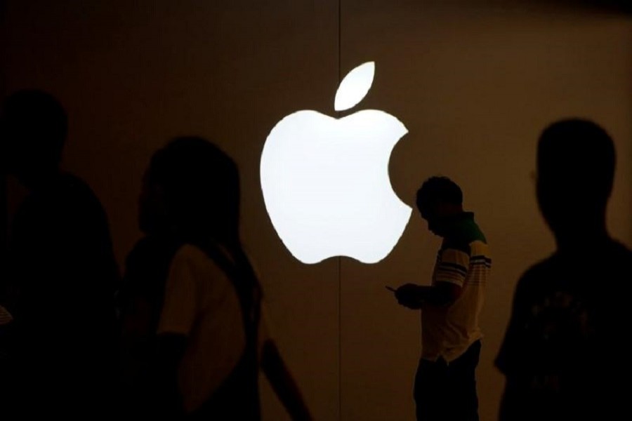 A man looks at the screen of his mobile phone in front of an Apple logo outside its store in Shanghai, China on July 30, 2017. Reuters/File Photo