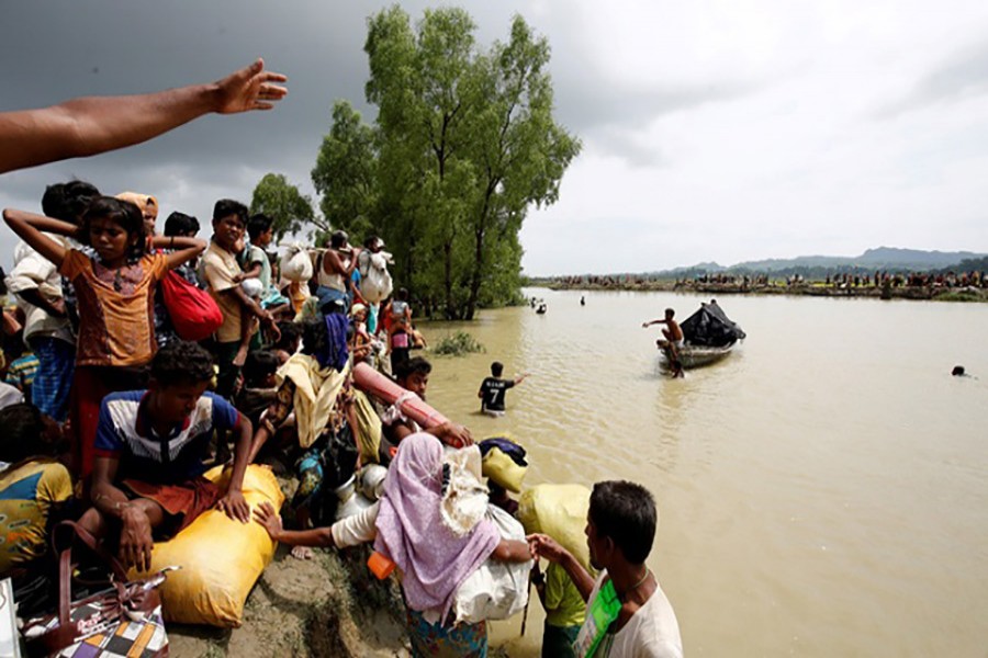 Rohingya refugees wait for boat to cross a canal after crossing the border through the Naf river in Teknaf, Bangladesh. - Reuters file photo