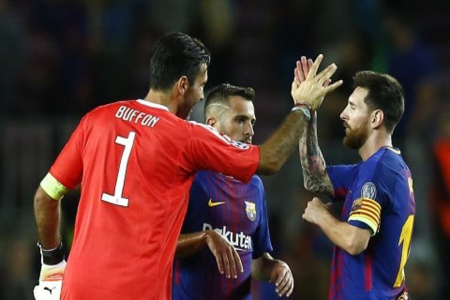 Barcelona's Lionel Messi shakes hands with Juventus goalkeeper Gianluigi Buffon at the end of a group D Champions League soccer match between FC Barcelona and Juventus at the Camp Nou stadium at Barcelona in Spain on Tuesday.	— AP