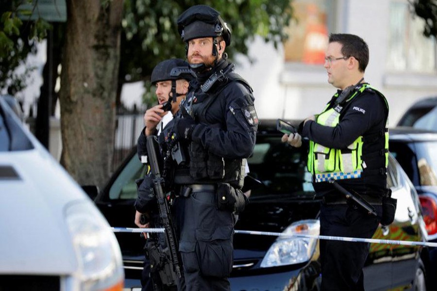 Armed policemen stand by cordon outside Parsons Green tube station in London, Britain on Friday. - Reuters