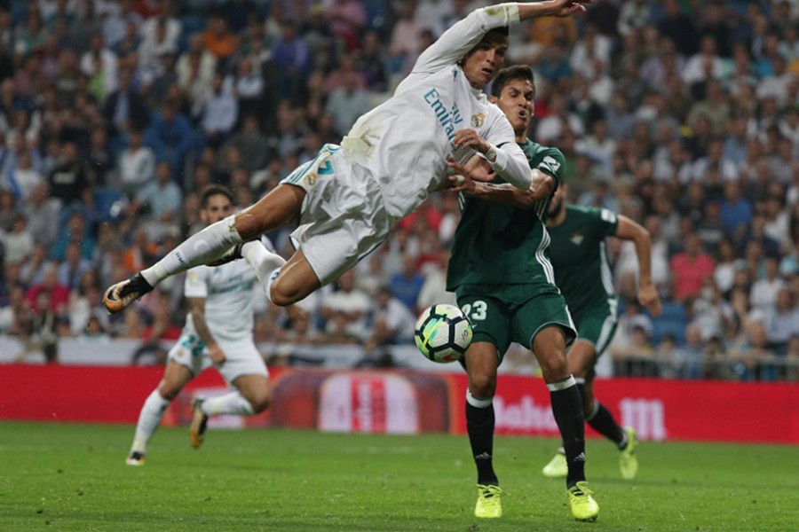 Real Madrid’s Cristiano Ronaldo in action with Betis' Aissa Mandi during Wednesday's clash. - Reuters photo