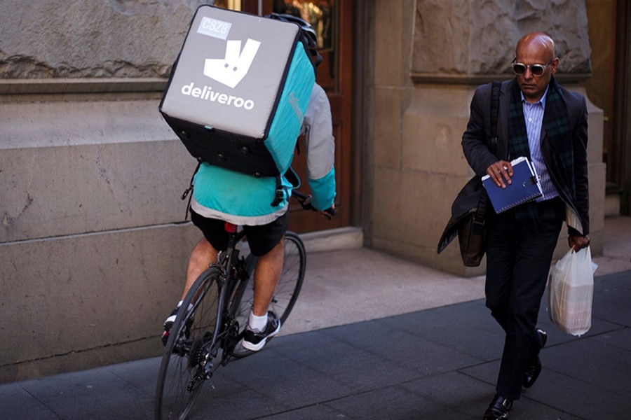 A cyclist rides a bicyle as he delivers food for Deliveroo. - Reuters file photo