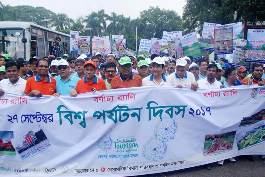 Civil Aviation and Tourism Minister Rashed Khan Menon joins a rally brought out from city's Matsya Bhaban intersection on Wednesday marking the 'World Tourism Day'. - Focus Bangla photo