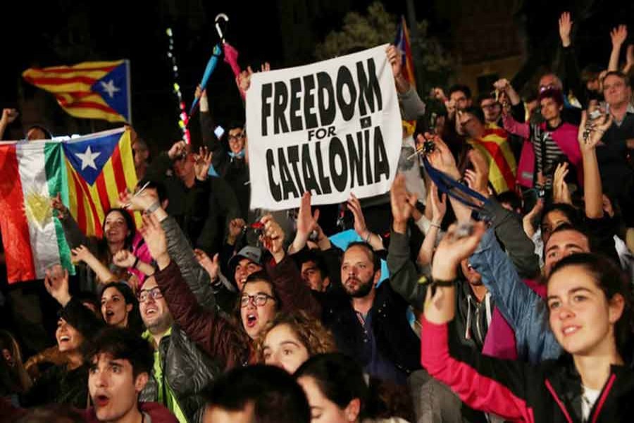 People react as they gather at Plaza Catalunya after voting ended for the banned independence referendum at Barcelona in Spain on Sunday.	— Reuters