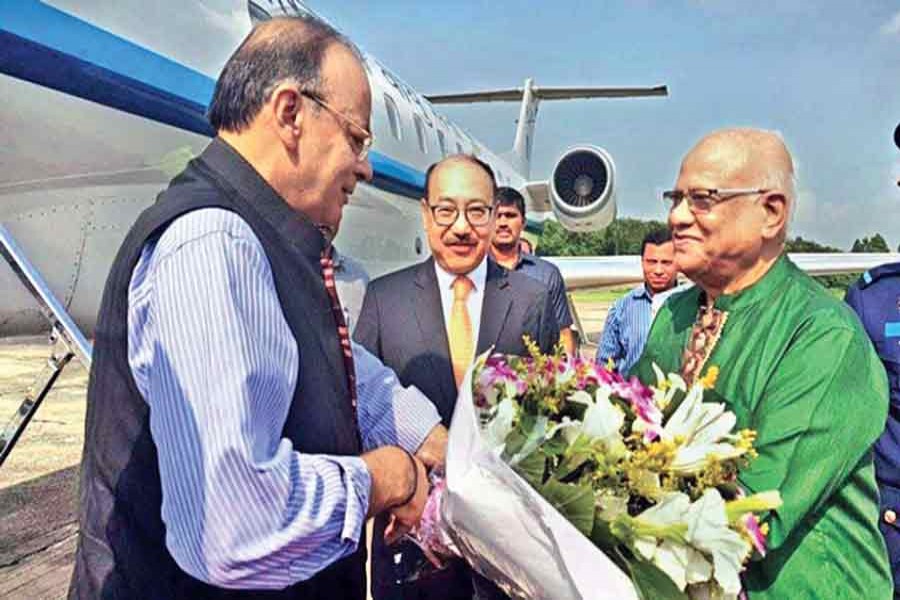 Finance Minister A M A Muhith receives his Indian counterpart Arun Jaitley on the latter's arrival in Dhaka on a three-day visit on Tuesday. 	— Collected