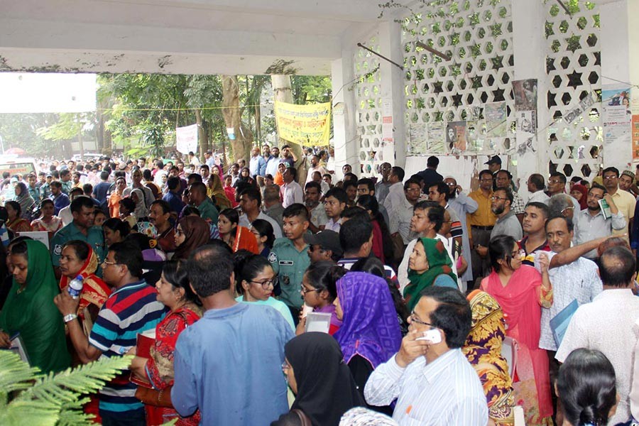 Anxious parents wait outside the Dhaka University's Arts Faculty building on Friday during the medical admission tests. - Focus Bangla photo