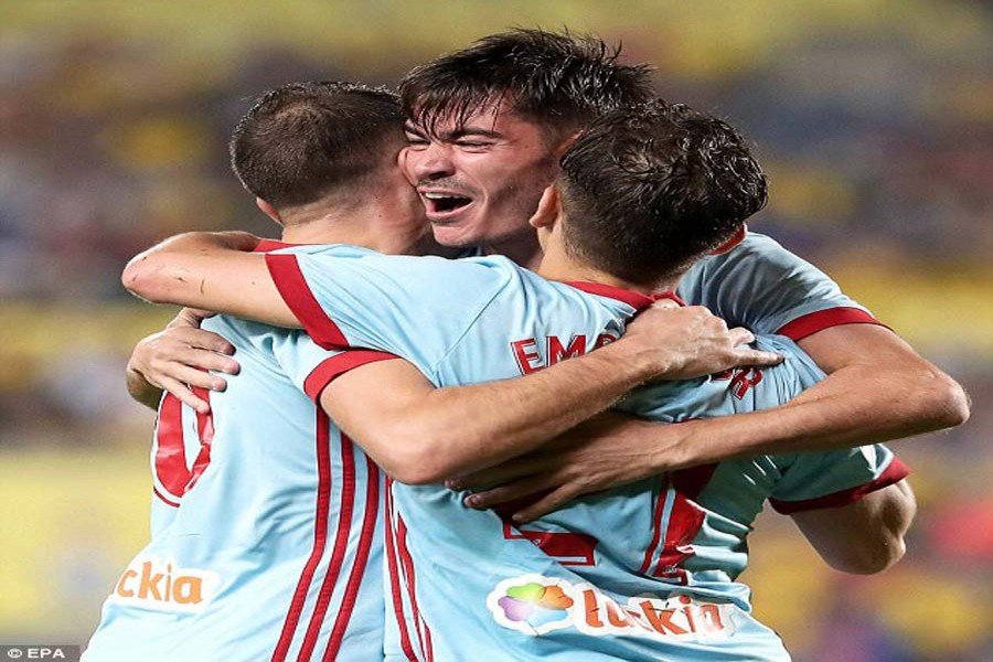 Aspas (L) celebrates with his teammates Jozabed (C) and Emre Mor (R) after scoring goal during the Spanish league match between Celta Vigo and Las Palmas at Gran Canaria Stadium in Madrid on Monday.	— Internet