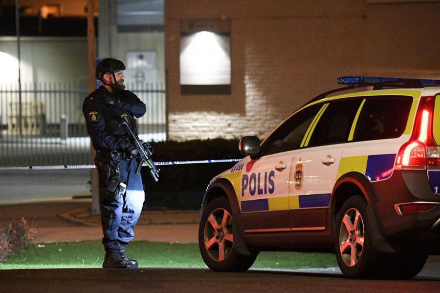 Police officer guards outside a cordoned area surrounding the police station in Helsingborg, Sweden, after a powerful explosion at the main entrance. (Reuters)