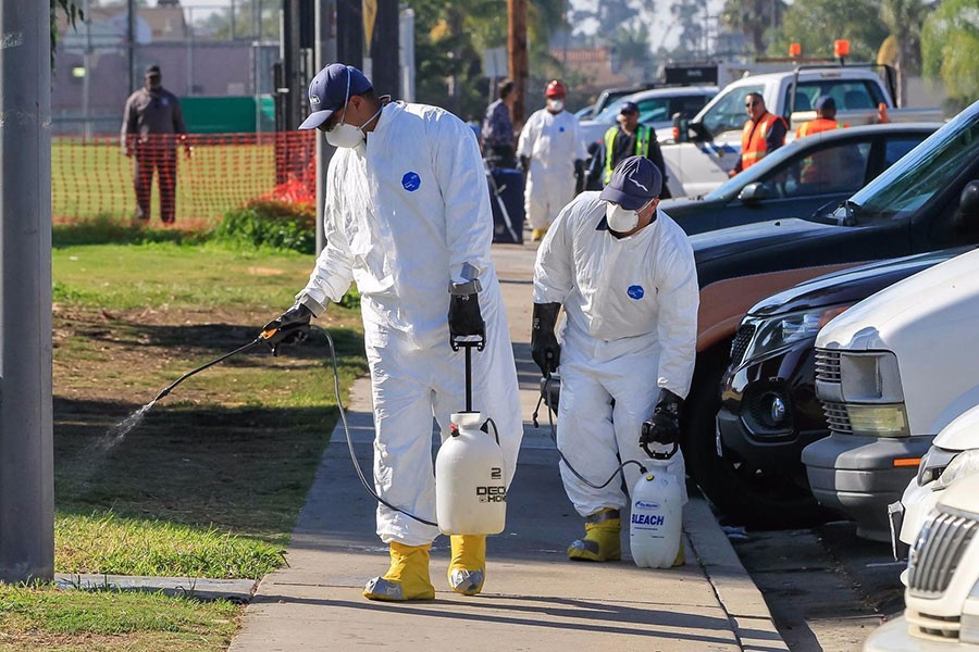 Work crews spray a bleach solution at North Park Community Park on October 13 as part of the battle against the hepatitis A outbreak in San Diego.  Photo courtesy: Los Angeles Times