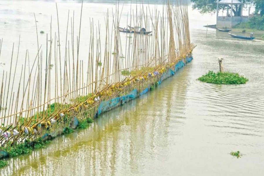 Illegal setting up of nets and bamboo enclosures is disrupting normal breeding of indigenous fish species at different points of Chalan Beel under Pabna district. The photo was taken on Thursday.	— FE Photo