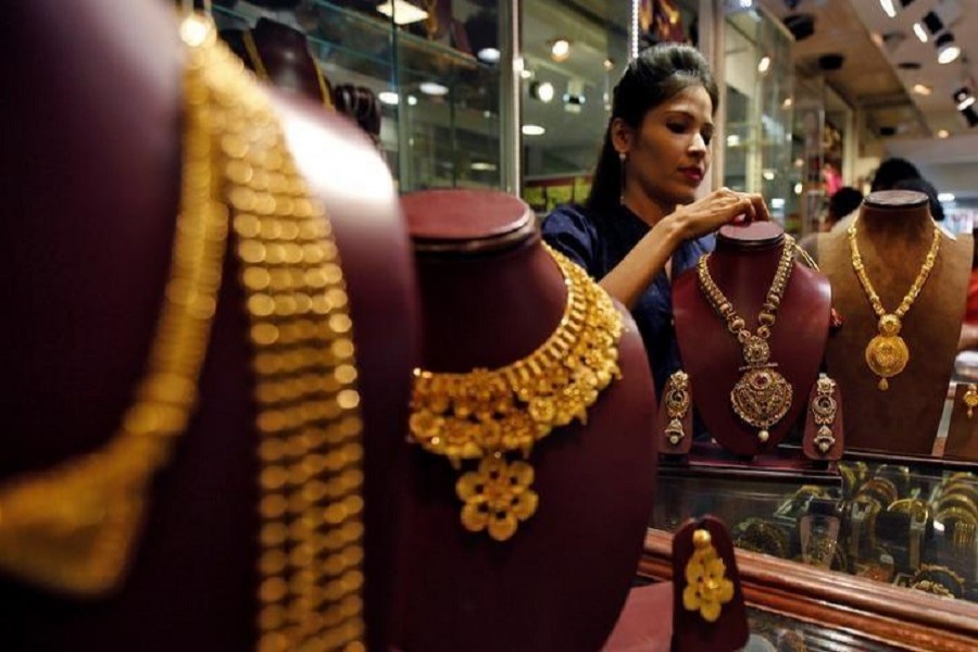 A salesperson attends to a customer (not pictured) inside a jewellery showroom, during Akshaya Tritiya, a major gold-buying festival, in Mumbai, India April 28, 2017. Reuters/Files