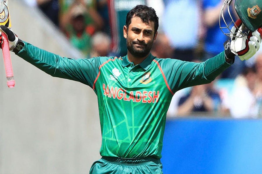 Tamim Iqbal raises his bat after scoring a century against England. (Photo: AP)