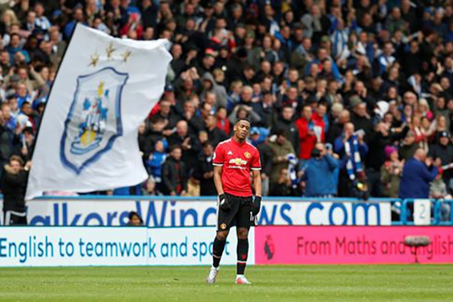 United's Anthony Martial cuts a dejected figure as his side crash to defeat at Huddersfield. - Reuters photo