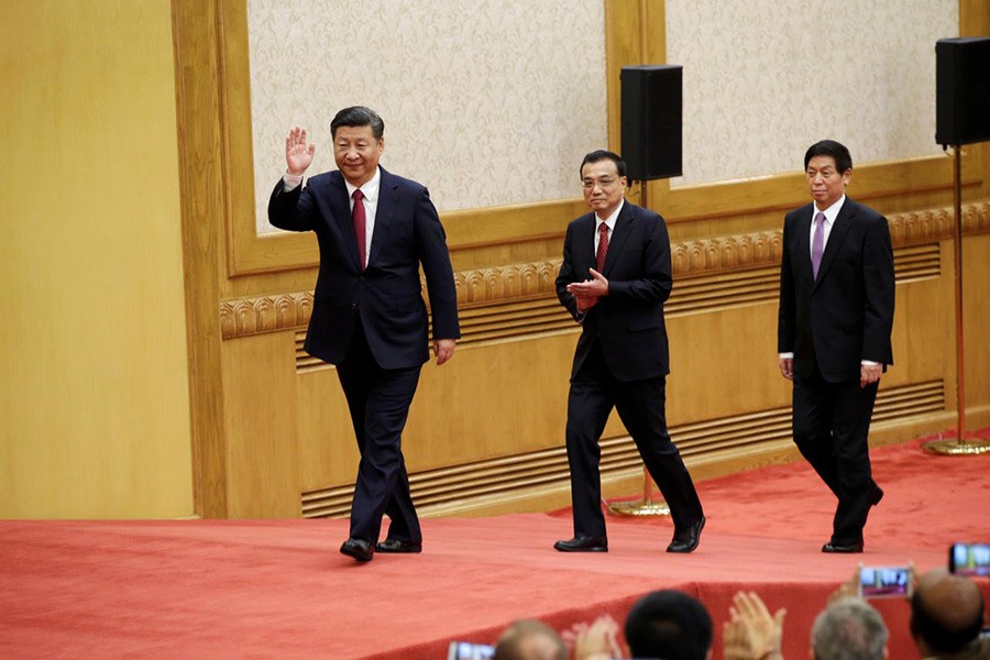 China's new Politburo Standing Committee members (L-R) Xi Jinping, Li Keqiang, and Li Zhanshu, arrive to meet with the press in Beijing on Wednesday. - Reuters photo