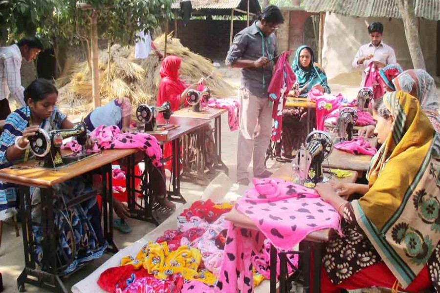 A group of female tailors are busy making clothes at Dhupchanchia upazila in Bogra on Thursday. 	— FE Photo
