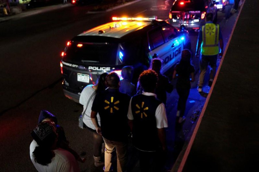 Walmart employees and shoppers leave the scene of a shooting at a Walmart in Thornton, Colorado on Wednesday. - Reuters