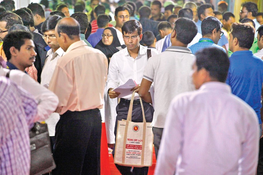 The central Tax Fair at Agargaon in the city experiences a heavy rush on Friday, a weekly holiday. A tax-payer is seen coming out of the fair after filing his tax return. 	—  FE photo