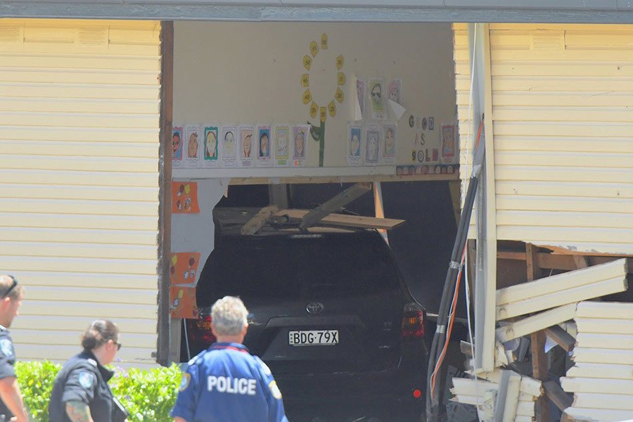 New South Wales emergency services personnel and police look at a vehicle that crashed into a primary school classroom in the Sydney suburb of Greenacre in Australia on Tuesday.