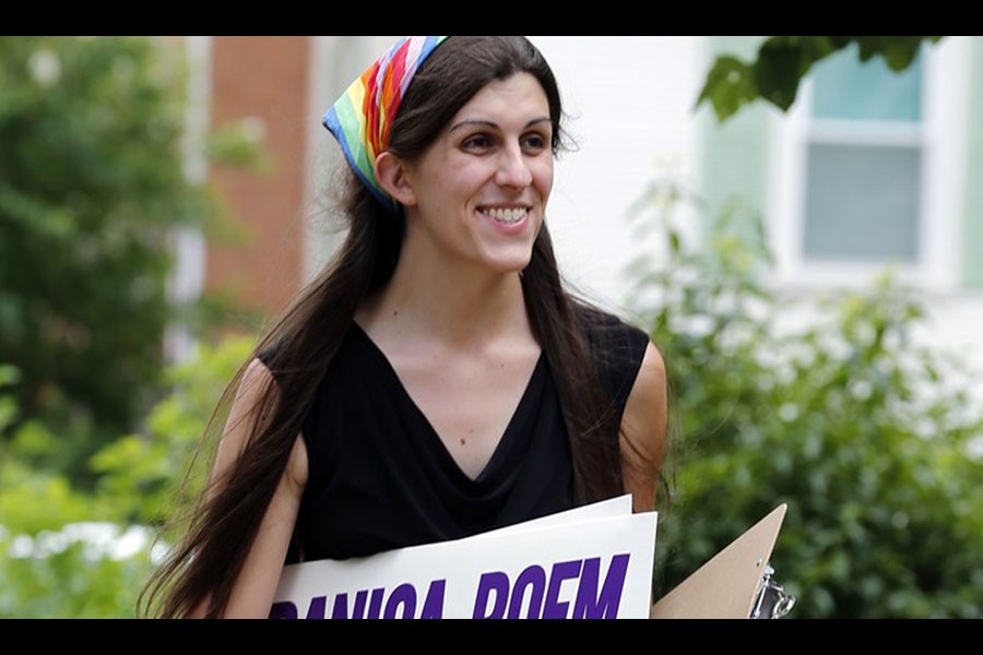 Democratic nominee for the House of Delegates 13th district seat Danica Roem brings campaign signs as she greets voters while canvasing a neighborhood in Manassas. (AP Photo)
