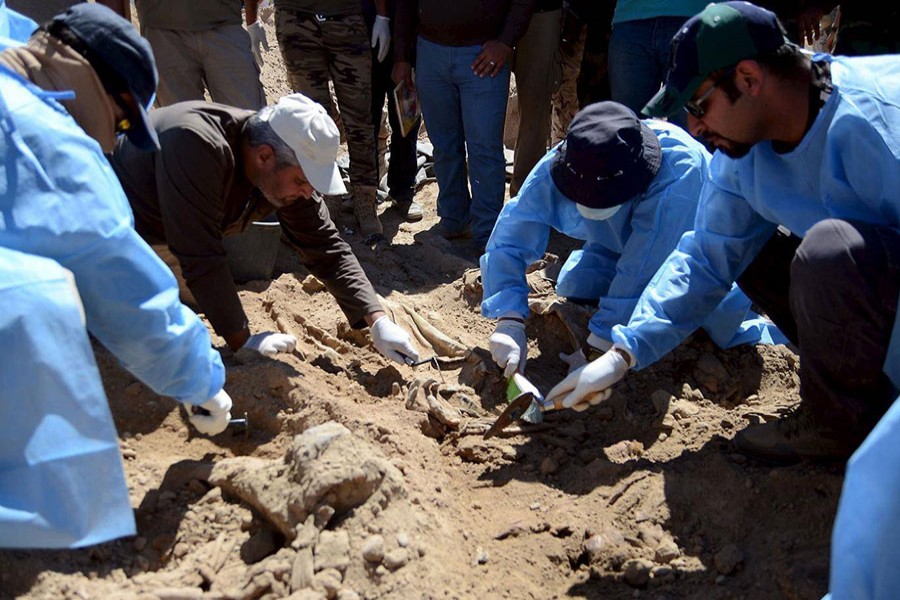 Members from the Iraqi forensic team search to extract the remains of the bodies. - Reuters file photo used for presentation.