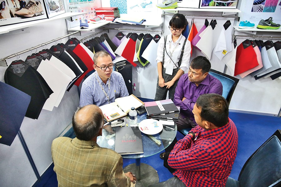 Company officials are negotiating with a buyer representative at a stall of the Bangladesh Leather Footwear & Leathergoods International Sourcing Show 2017, which began in Dhaka Thursday.   	— FE Photo