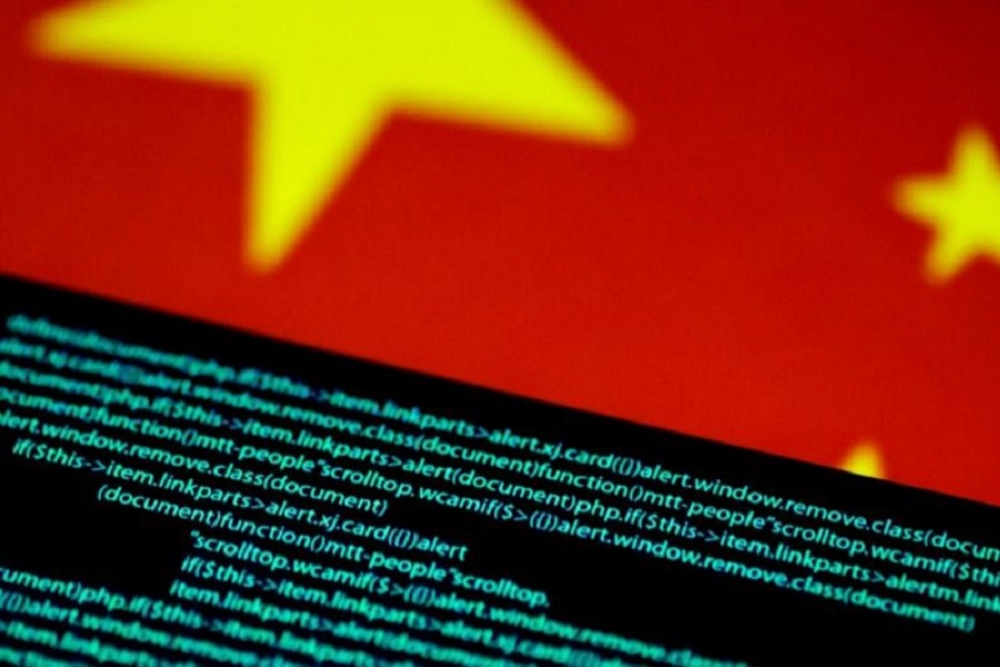 Computer code is seen on a screen above a Chinese flag in this July 12, 2017 illustration photo. Reuters/Illustration/Files