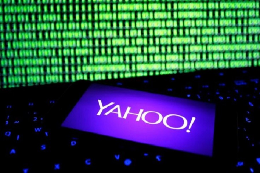 A photo illustration shows a Yahoo logo on a smartphone in front of a displayed cyber code and keyboard on December 15, 2016. Reuters/Illustration