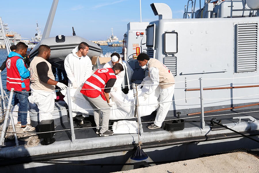 The dead, including a number of children, were brought back to Tripoli naval base where they were unloaded in white plastic body bags. - Reuters