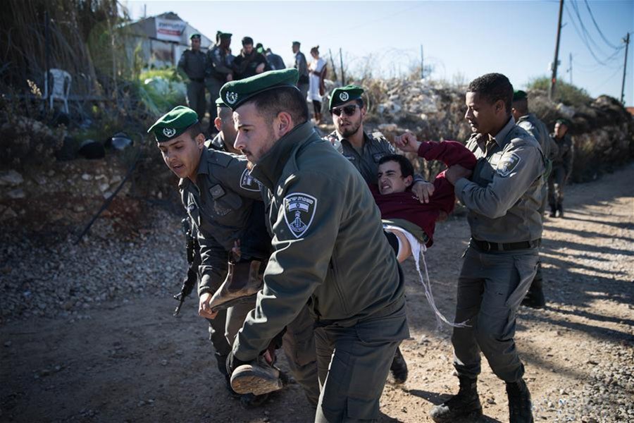 Israeli police scuffle with Jewish settlers during the evacuation of a building in Netiv Ha'avot, south of Jerusalem on Wednesday. - Xinhua photo