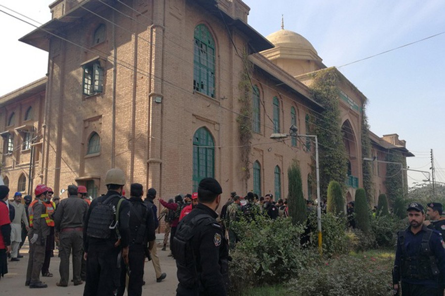 Police and rescue workers stand outside the Directorate of Agriculture Institute in Peshawar, Pakistan on Friday. Reuters