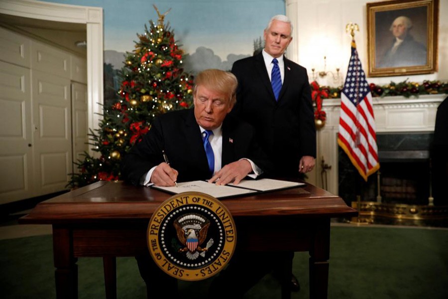 With Vice Pence Mike Pence looking on, U.S. President Donald Trump signs an executive order after he announced the U.S. would Jerusalem as the capital of Israel on Wednesday. - Reuters photo