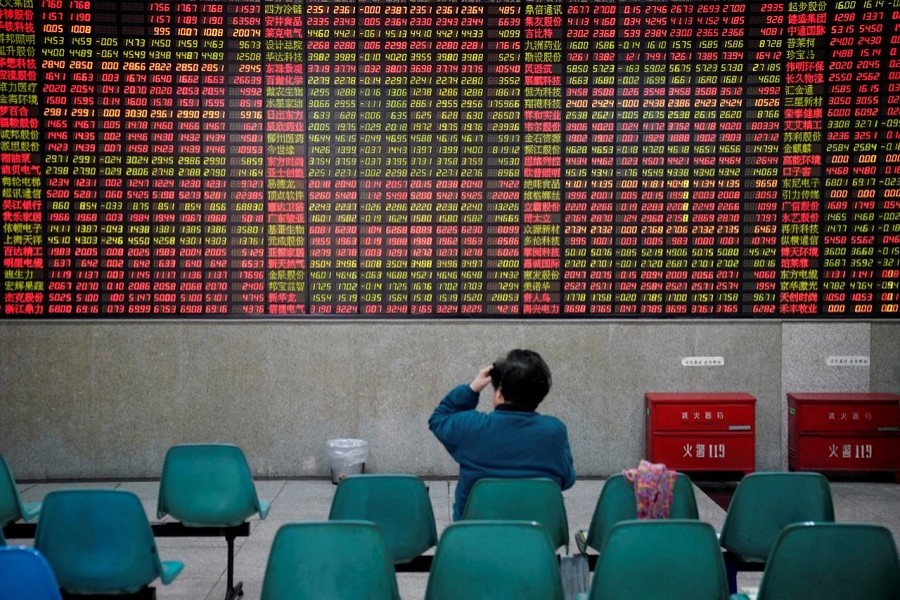 An investor looks at an electronic board showing stock information at a brokerage house in Shanghai, China November 24, 2017. Reuters