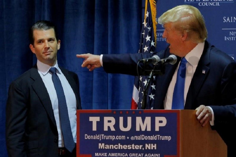 Then US Republican presidential candidate Donald Trump (R) welcomes his son Donald Trump Jr. to the stage at an event in Manchester, New Hampshire November 11, 2015. Reuters/File Photo