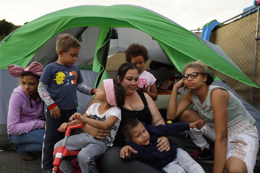 Christine Wade sits among her children at their donated tent in a city-sanctioned encampment:AP Photo