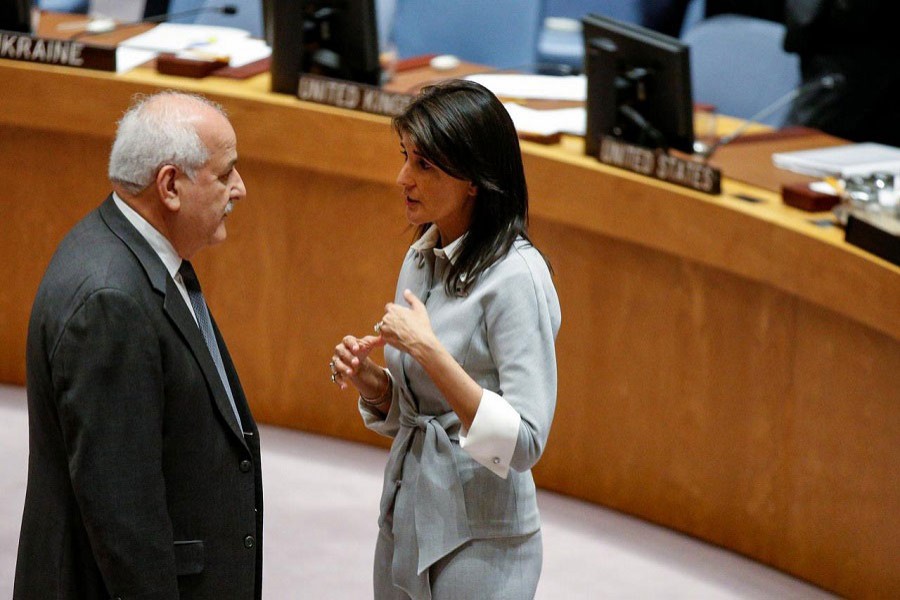 US ambassador to the UN Nikki Haley speaks with Permanent Observer to the State of Palestine to the UN, Riyad Mansour at the UN Headquarters, December 8, 2017. Reuters