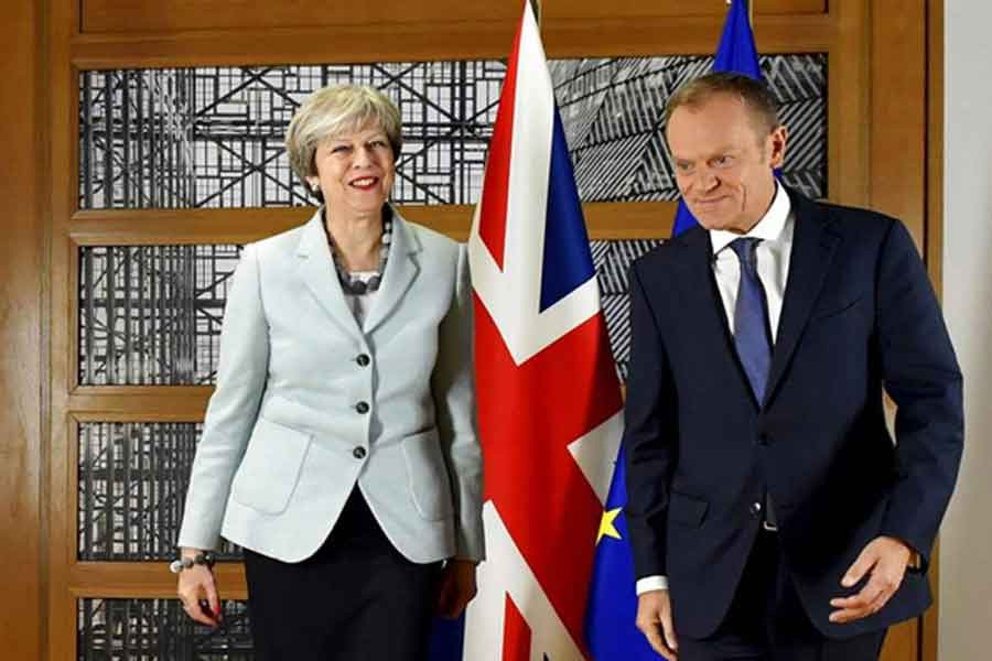 British Prime Minister Theresa May, left, walks with European Council President Donald Tusk prior to a meeting at the Europa building in Brussels on December 08, 2017. -- Photo: AP