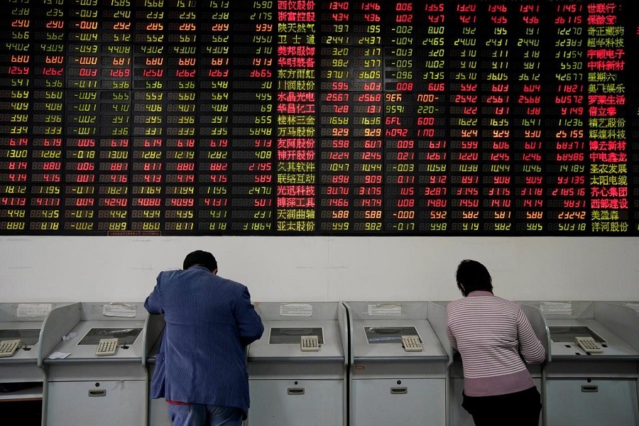 Investors look at computer screens showing stock information at a brokerage house in Shanghai, China November 24, 2017. Reuters