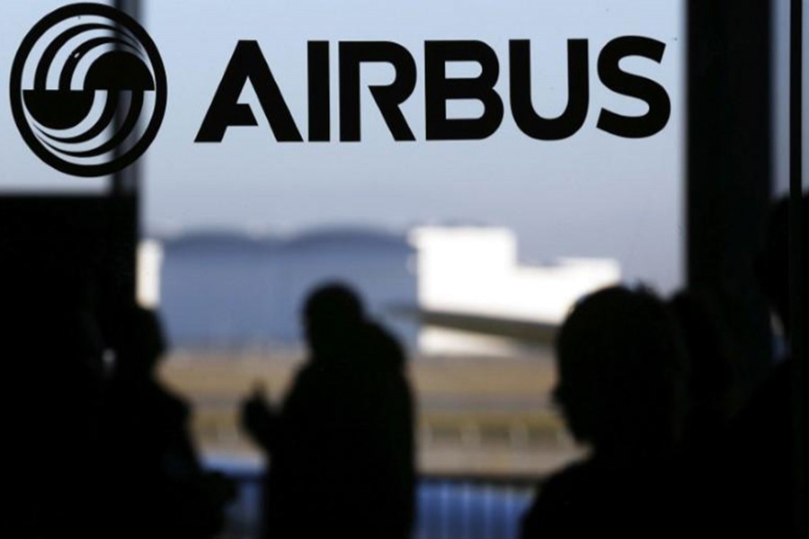 People are silhouetted past a logo of the Airbus Group during the Airbus annual news conference in Colomiers, near Toulouse January 13, 2015. - Reuters file photo