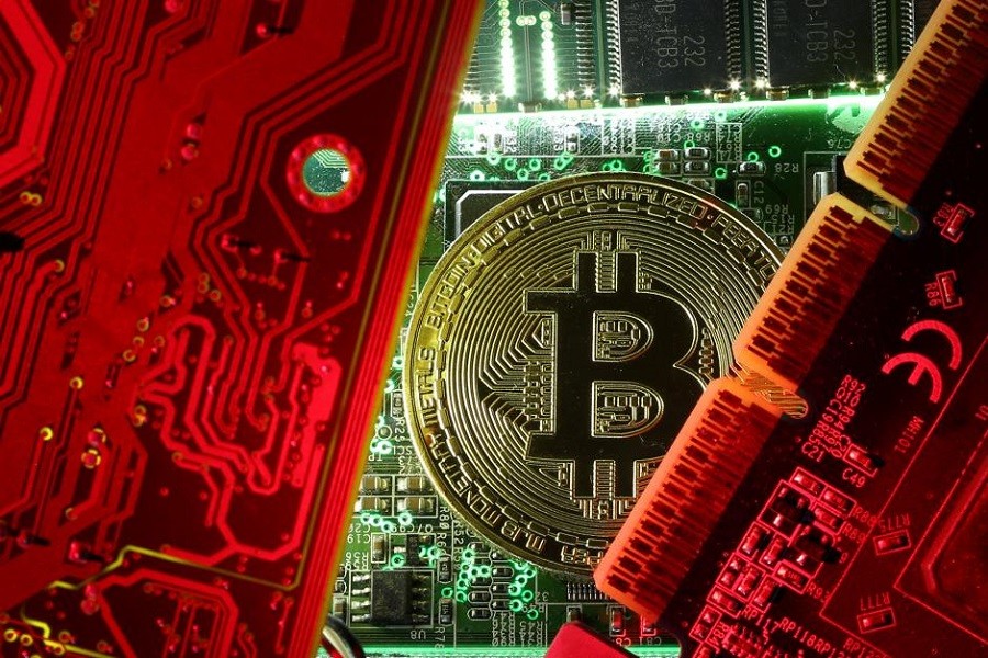 A coin representing the bitcoin cryptocurrency is seen on computer circuit boards in this illustration picture, October 26, 2017. Reuters/File Photo
