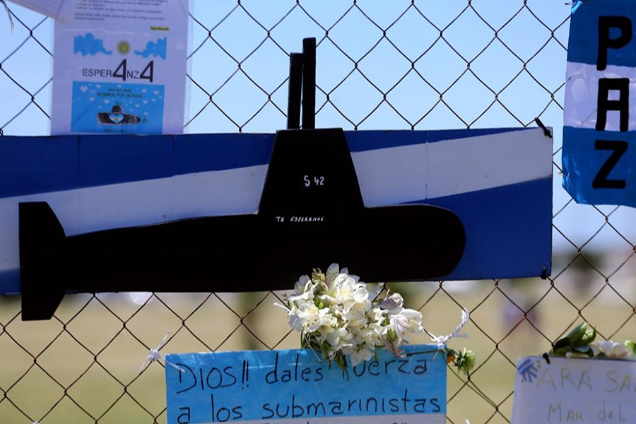 A bouquet of flowers and banners in support of the 44 crew members of the missing at sea ARA San Juan submarine are placed on a fence outside an Argentine naval base in Mar del Plata, Argentina November 25, 2017. - Reuters file photo