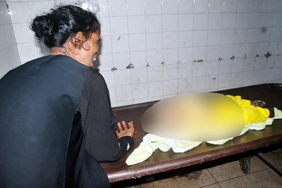 A woman breaks down as she sees her baby lying dead on a stretcher at Dhaka Medical College and Hospital on Monday: Photo: Focus Bangla