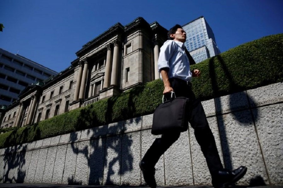 A man runs past the Bank of Japan (BOJ) building in Tokyo, Japan, July 29, 2016. Reuters/File Photo