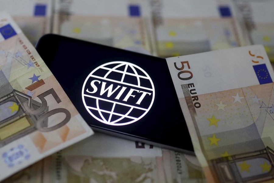 Swift code bank logo is displayed on an iPhone 6s on top of Euro banknotes in this picture illustration. - Reuters