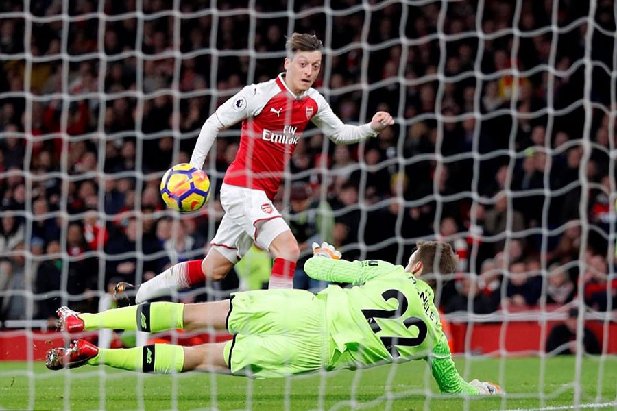 Ozil put Arsenal 3-2 ahead after finishing a well worked move by chipping the ball over Liverpool goalkeeper Simon Mignolet. - Reuters photo