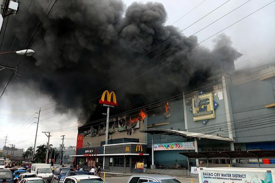 Smoke billows from a shopping mall on fire in Davao City, the Philippines, in this photo obtained from social media. - via Reuters