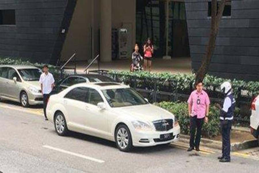 A Land Transport Authority enforcement officer of Singapore conducts his routine patrol along Prinsep Street when he noticed two vehicles belonging to President Halimah Yacob's convoy parked along double yellow lines on Wednesday: Facebook