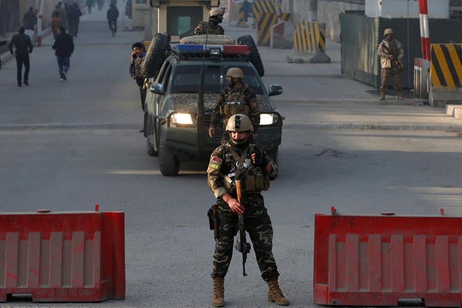 Afghan security forces keep watch at a check point close to the compound of Afghanistan's national intelligence agency in Kabul, Afghanistan on Monday. - Reuters photo