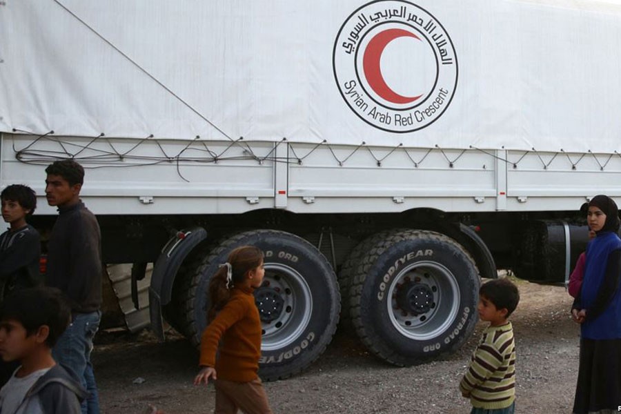 People stand next to Syrian Arab Red Crescent truck in the town of Nashabiyeh, eastern Ghouta in Syria, Nov. 28, 2017. (Picture used for representational purpose)