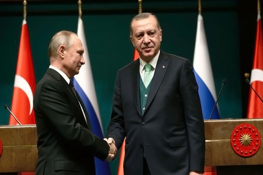 Turkey's President Recep Tayyip Erdogan, right, shakes hands with Russia's President Vladimir Putin following their joint news statement after their meeting at the Presidential Palace in Ankara, Turkey, on Dec 11. (Associated Press)